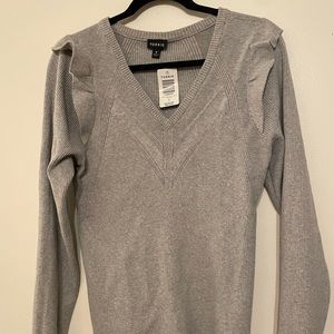 Gray long sleeve sweater with flutter shoulder detail